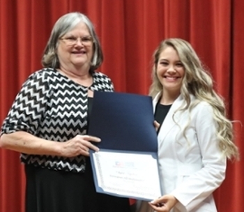 Lori Moseley presenting an Exemplary ATI Performance award to Shyloh Napoleon of Burleson.